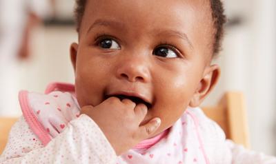 Toddler with hand in mouth